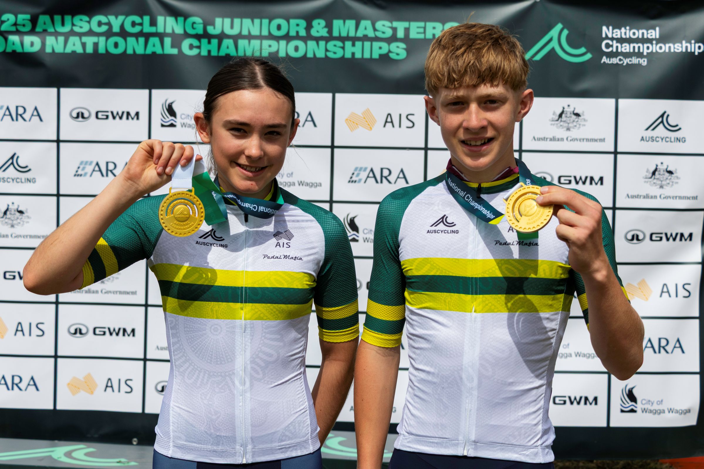 Queensland's Hannah Walters and Reilly Dickson with the national jerseys for the under-15 road race at the AusCycling Junior Road National Championships in 2025 in Wagga Wagga